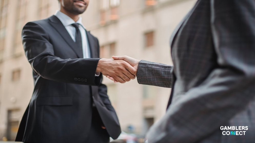 A bird's-eye view of a green football pitch with the Brazilian flag in the center, used as a conceptual representation of global sports betting and gaming market expansion.