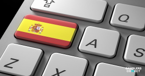 A close-up of a computer keyboard featuring a key with the Spanish flag, representing Spain's digital Safe Gambling Program.