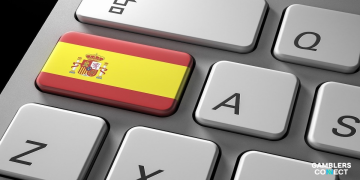A close-up of a computer keyboard featuring a key with the Spanish flag, representing Spain's digital Safe Gambling Program.