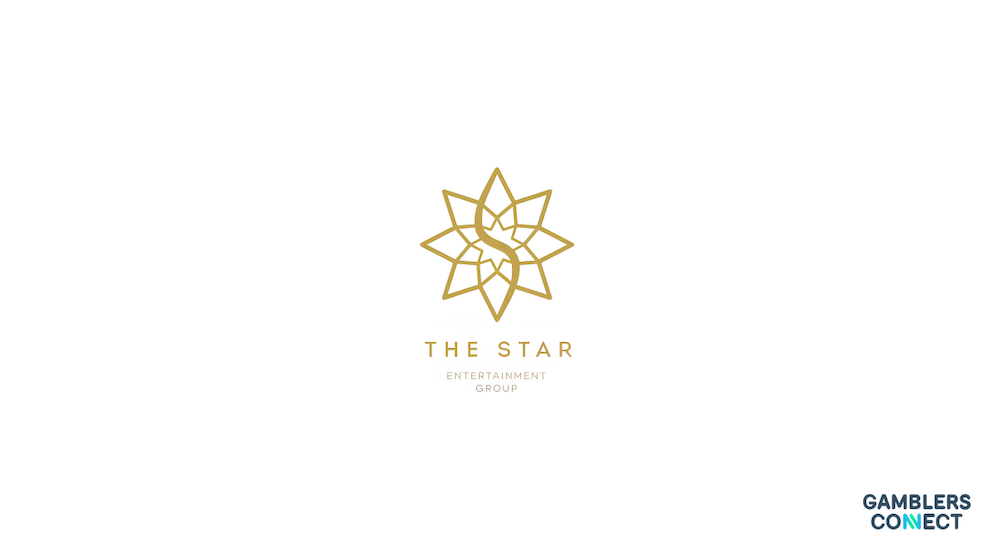The Star Entertainment Group Names Ameet Patel as Dual CEO for Brisbane and Gold Coast Properties 1 A close-up business handshake between two corporate executives in suits, framed over an office desk containing financial charts and documents against a blurred boardroom window view.