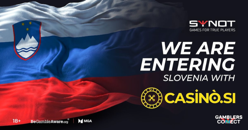 The fabric texture of the Slovenian flag billowing dynamically against a dark background featuring the official SYNOT Games corporate emblem.