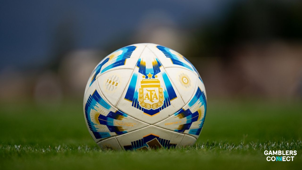 An official Argentina national football team ball sitting on a green pitch layout.