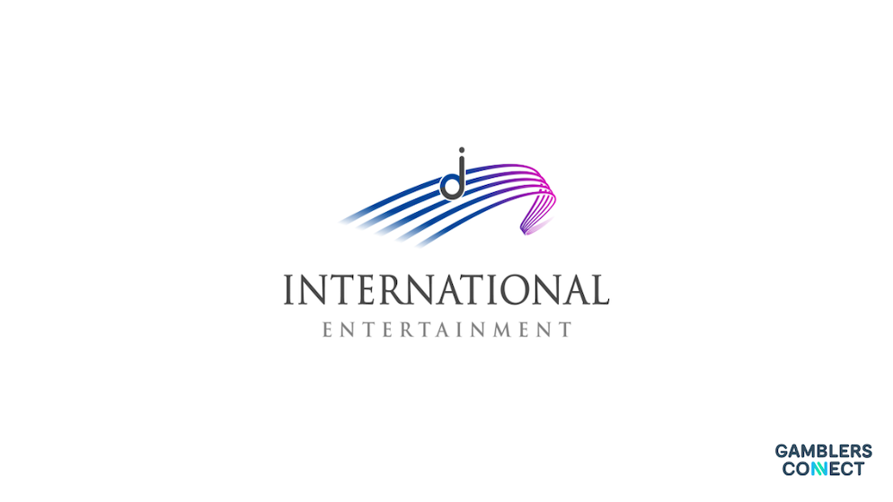 The minimalist corporate logo of International Entertainment presented as a stylized grey letter J floating over blue and purple curved musical staff lines on a white background.