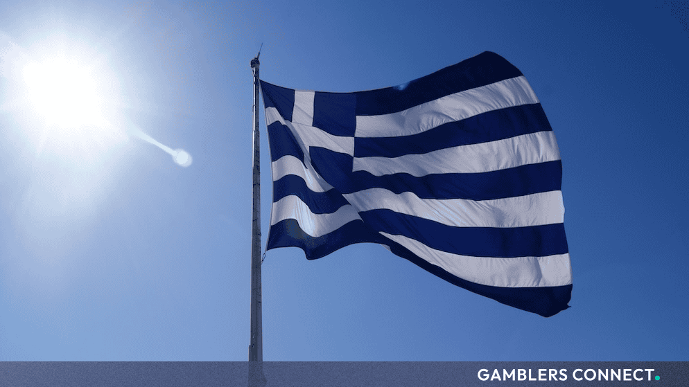 Greece Escalates Regulatory Crackdown on Unlicensed Gambling Promotion via Influencer Streaming Networks 1 Low-angle shot of the Greek flag under direct sunlight, representing the tightening of national regulatory and financial compliance frameworks.