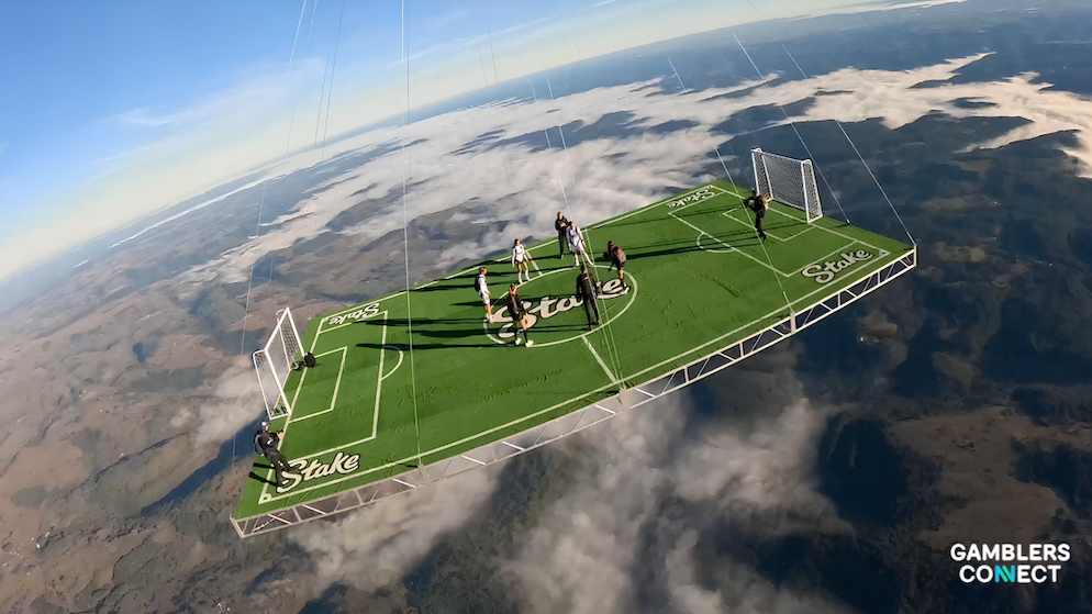 Top-down drone view of the 12m x 20m hot air balloon football pitch displaying Stake corporate branding on the synthetic turf.