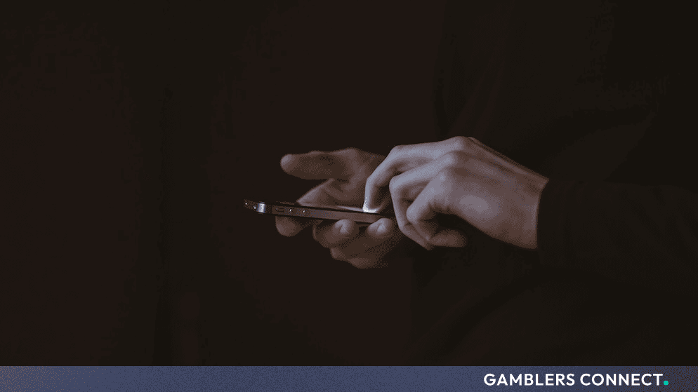 Gamstop Reports All-Time High Self-Exclusions in May 2026 1 A close-up shot of a smartphone screen being touched, symbolizing a user accessing the official Gamstop platform to register for self-exclusion.
