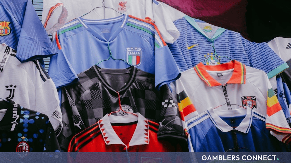 Assortment of football jerseys hanging on display, including an Italy national team shirt representing international football developments.