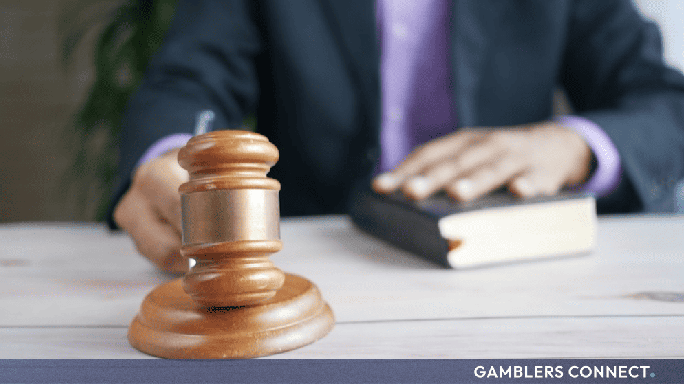 Close-up of a legal gavel and legal professional, illustrating the civil penalty consequences facing non-compliant iGaming operators.