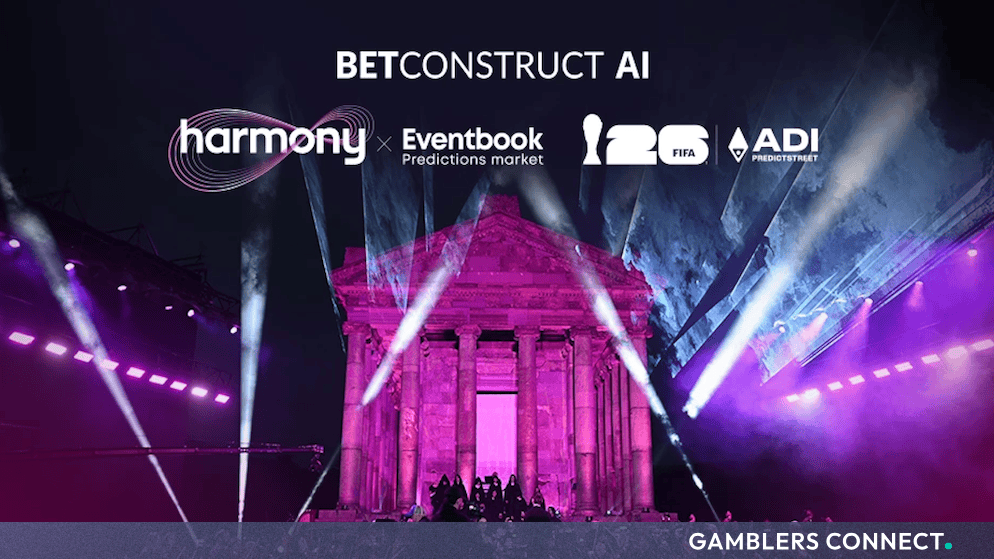 BetConstruct AI Concludes Landmark "Harmony Predictstreet" Summit in Yerevan 1 A wide night promotional photo showing the ancient Garni Temple illuminated in striking pink and purple projection lighting. Superimposed white text displays the "BETCONSTRUCT AI" master brand, alongside corporate logos for "Harmony", "Eventbook Predictions Market", the "2026 FIFA World Cup", and "ADI PREDICTSTREET". The Armenian National Philharmonic Orchestra is visible performing at the base of the temple stage.