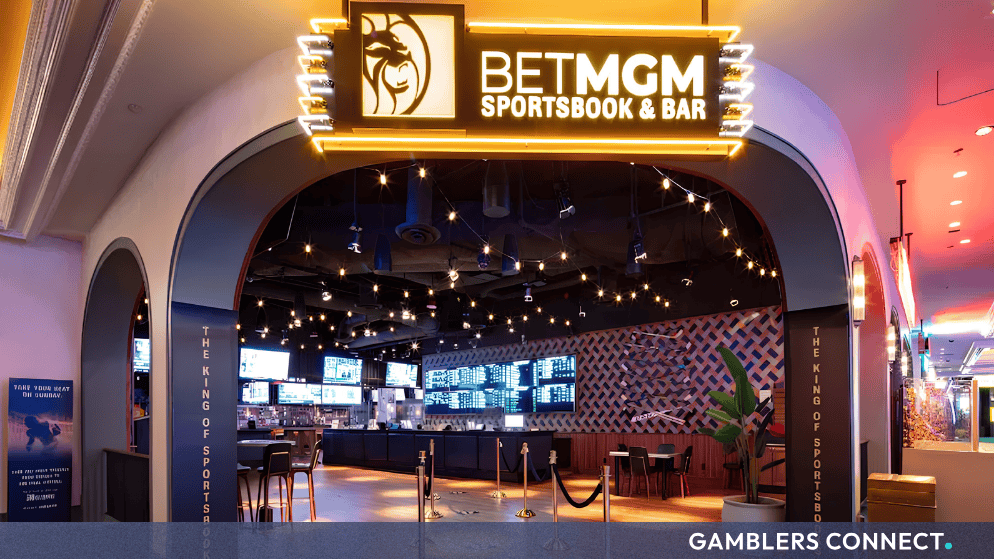 Exterior entrance of the BetMGM Sportsbook & Bar at Park MGM in Las Vegas featuring glowing signage and screens.