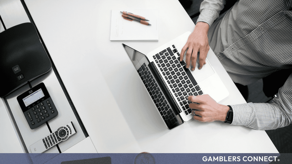 An executive working in an office environment, symbolizing the central alignment of sports betting operations across multiple international jurisdictions.