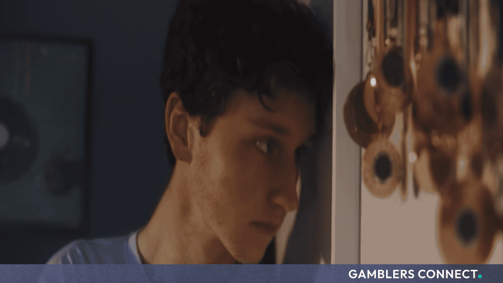 A teenage boy showing signs of fatigue and stress, symbolizing the hidden nature of online gaming and gambling addictions.