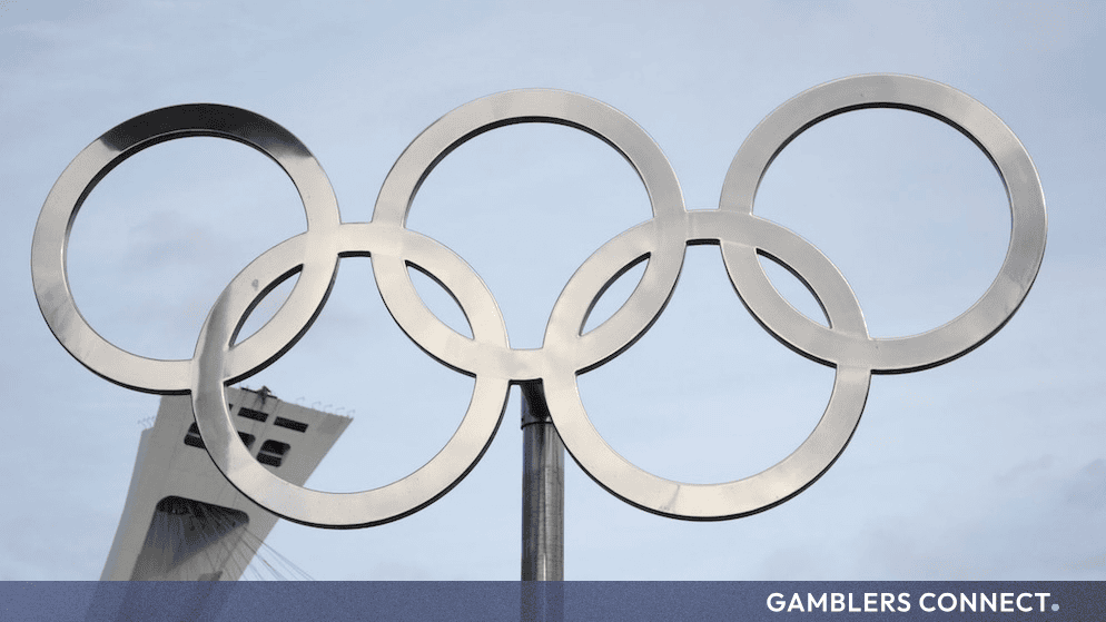Close-up view of the metallic Olympic rings emblem, representing international sports federation compliance under the Olympic Charter.