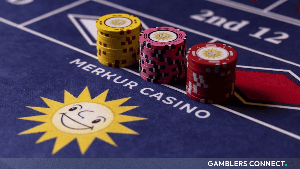 Close-up of corporate-branded casino chips arranged on a blue gaming table layout, representing property enhancements and brand standardization.