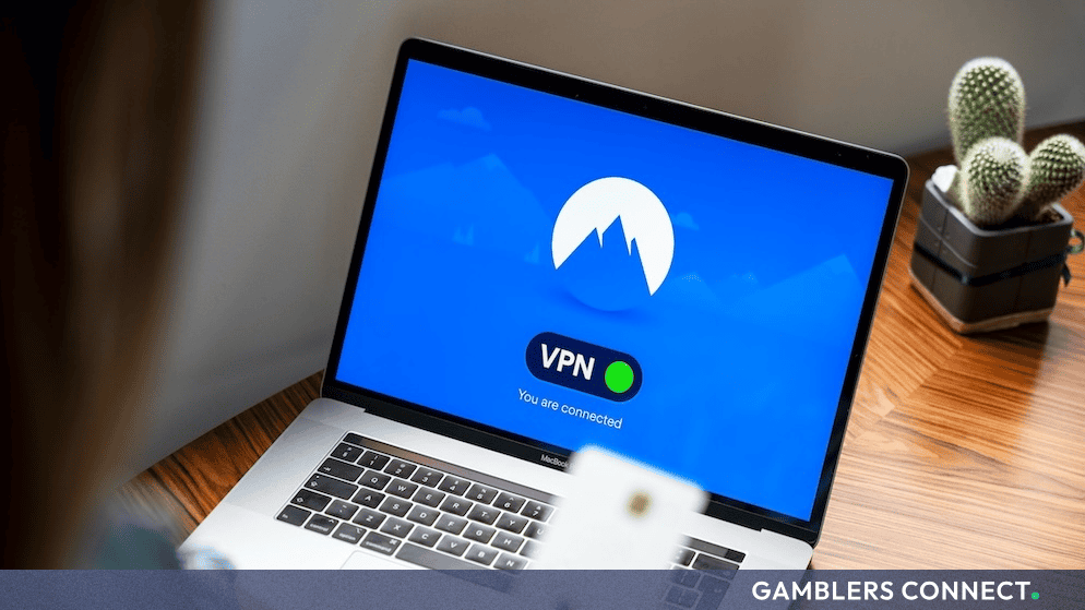 Laptop screen displaying the NordVPN interface and connection status on a wooden desk.