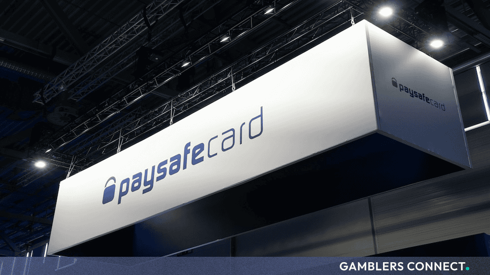 Paysafecard promotional installation banner under exhibition lighting, symbolizing alternative payment method infrastructure for global gaming platforms.