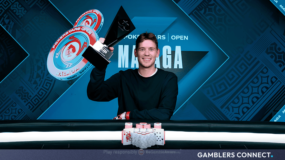 Main event winner Oskar Bilstad holding his championship trophy at the final table layout during the PokerStars live tournament series.