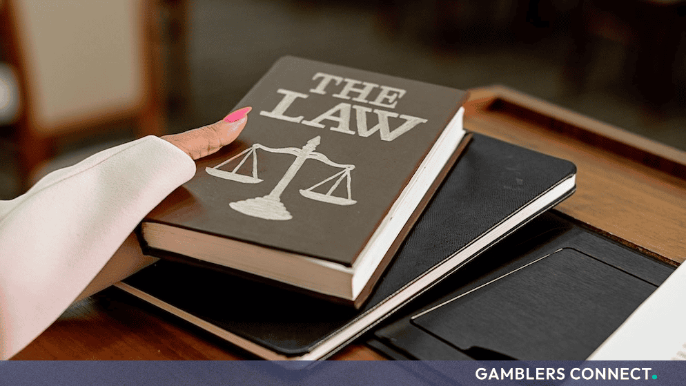 A legal book titled 'The Law' sitting on a workspace, representing New York General Business Law and breach of contract enforcement.