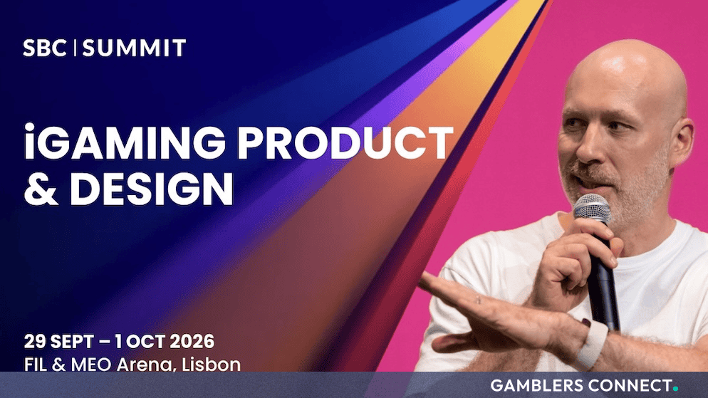 Speaker at the SBC Summit in Lisbon holding a microphone during the iGaming Product & Design track presentation.
