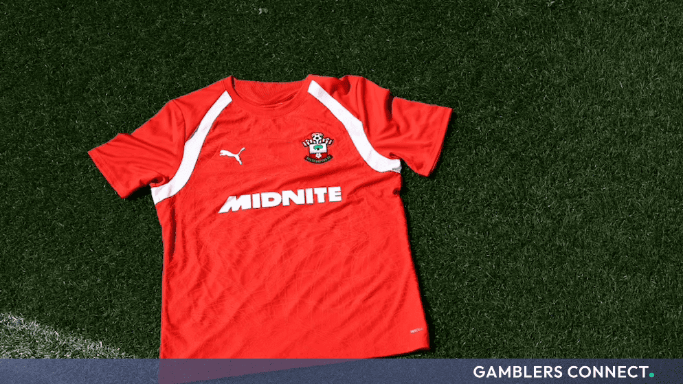Close-up of the official Southampton Football Club training jersey displaying the Midnite commercial brand mark next to the Gamblers Connect partner logo.