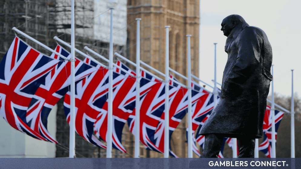 British flags flying near the Houses of Parliament representing the UK government.
