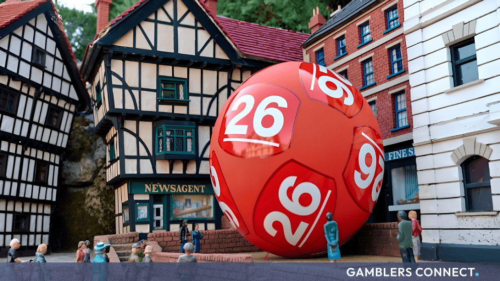 US Powerball Launches in the UK with £300 Million Debut Jackpot 1 Large red Powerball lottery ball installation set against a traditional UK model village backdrop.