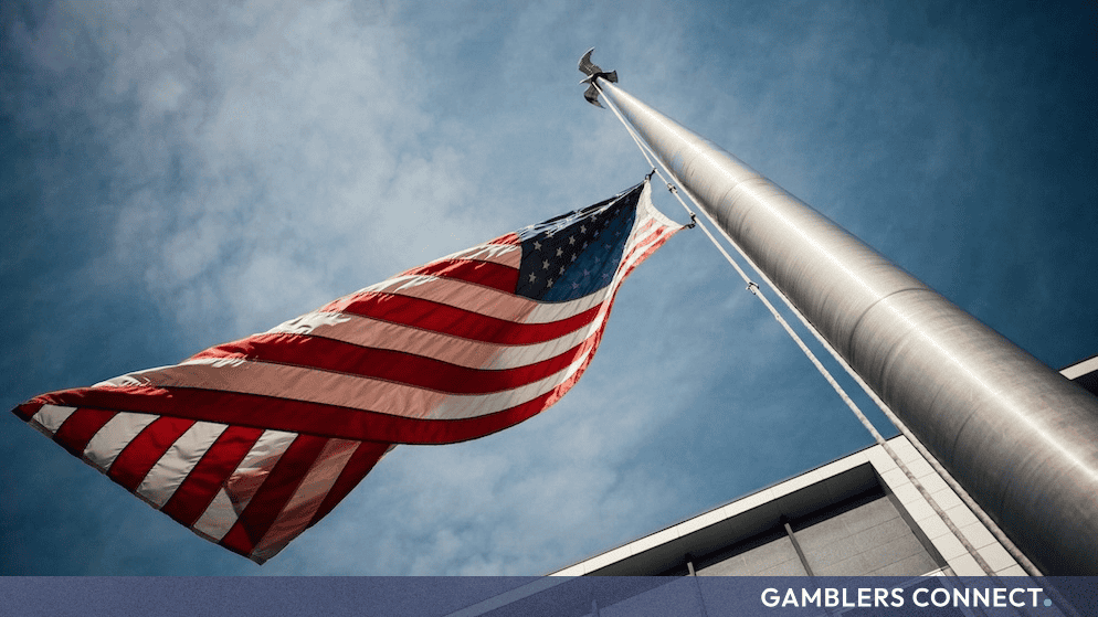 American flag against a blue sky representing federal oversight and the White House.