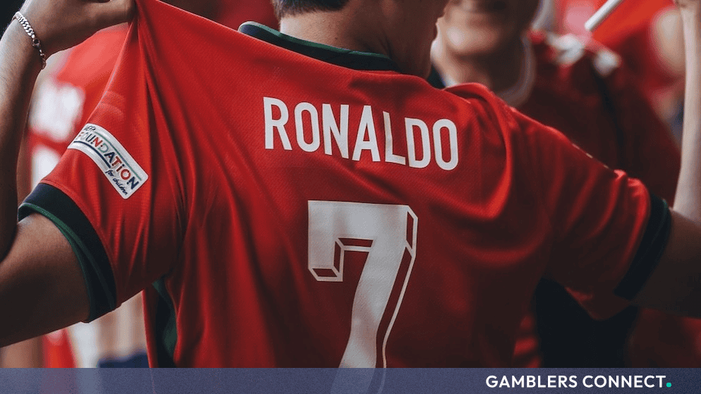 A football fan wearing a red Portugal national team jersey with "RONALDO" and the number 7 on the back.