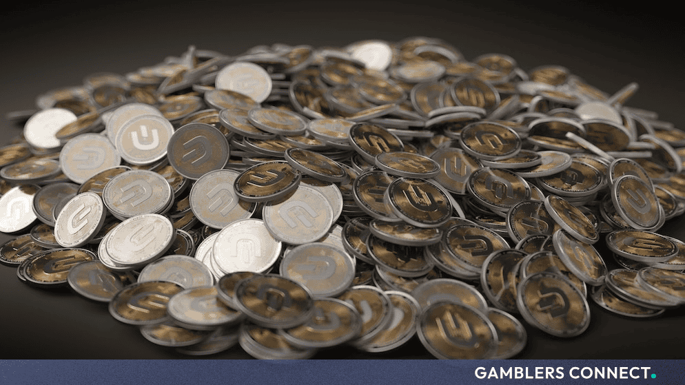 A large pile of digital asset and stablecoin tokens reflecting cryptocurrency payout systems and blockchain transactions.