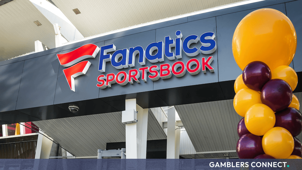 The exterior entrance of a Fanatics Sportsbook venue decorated with yellow and burgundy balloons.