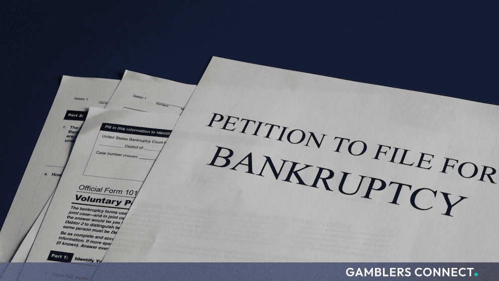 Official legal paperwork and bankruptcy petition documents resting on a dark surface, representing corporate insolvency and legal proceedings.
