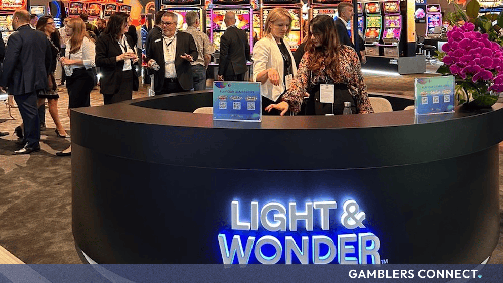 Attendees interacting with gaming hardware and displays at a Light & Wonder corporate showcase event.