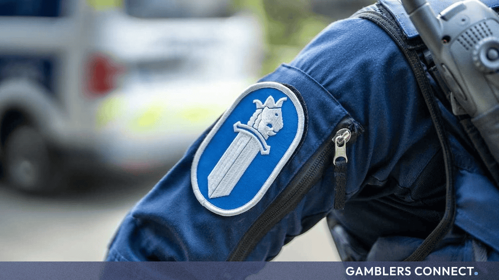 Close-up of a Finnish police uniform sleeve showing the sword-lion emblem patch.