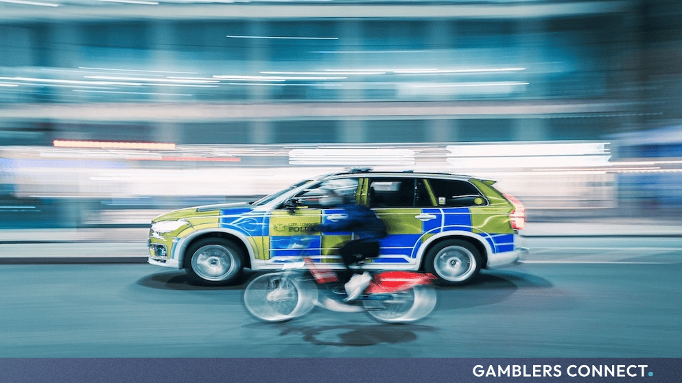 Law enforcement vehicles and police officers conducting multi-agency operations on a UK high street.