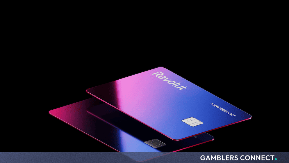 Sleek 3D rendering of blue and purple gradient Revolut branded debit cards against a dark background.