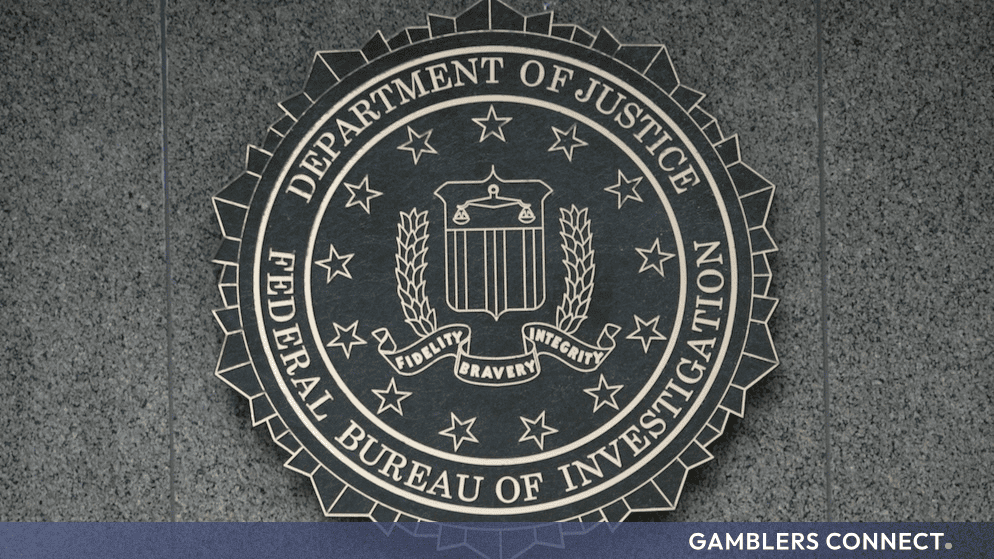 The official Department of Justice and Federal Bureau of Investigation seal mounted on a structured stone wall.