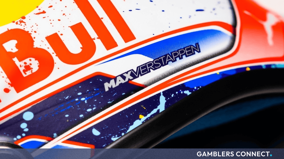 Max Verstappen in Red Bull racing gear celebrating on the podium following a strong performance during the Formula 1 season.