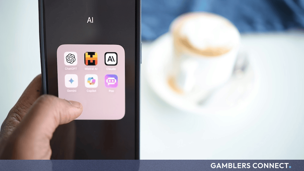 A person holding a smartphone displaying various artificial intelligence application icons on its screen.