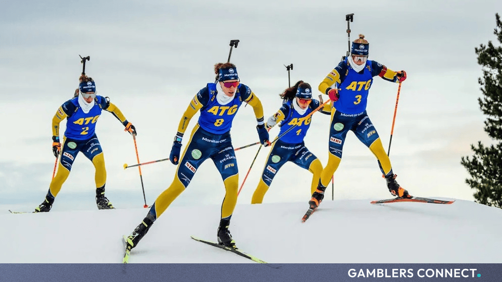 Swedish biathlon team members competing in yellow and blue racing uniforms featuring ATG branding.