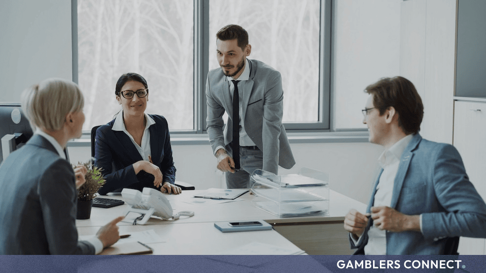 Professional corporate team collaborating in a modern office environment during a business strategy meeting.