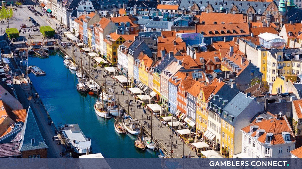 Aerial view of a historic canal and colorful buildings in Copenhagen, Denmark.