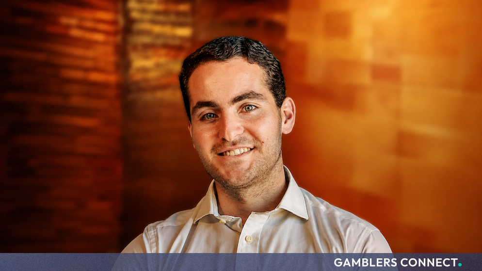Professional portrait of Edward Fenech Adami, Head of Legal at Gentoo Media, smiling against a warm, blurred background.
