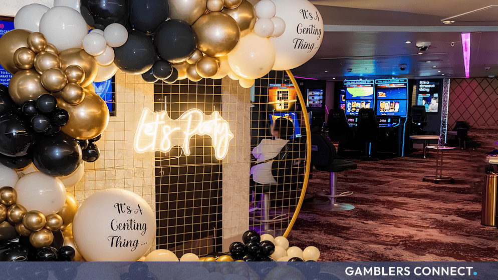 Festive gold, white, and black balloon arrangement featuring a "Let's Party" neon sign celebrating the Genting Casino Manchester relaunch.