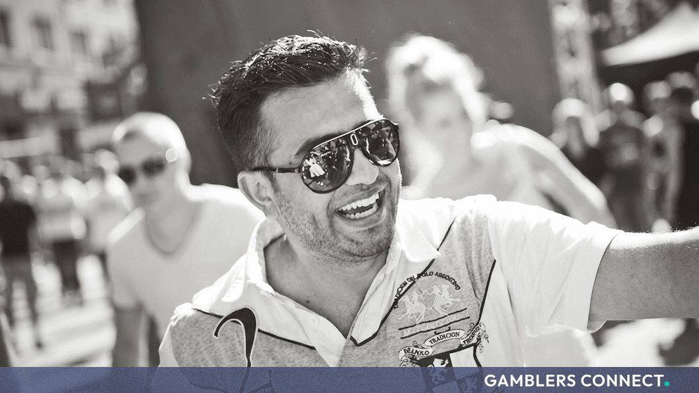 Black and white portrait of Hasse Sahar wearing sunglasses and smiling outdoors during an industry event.