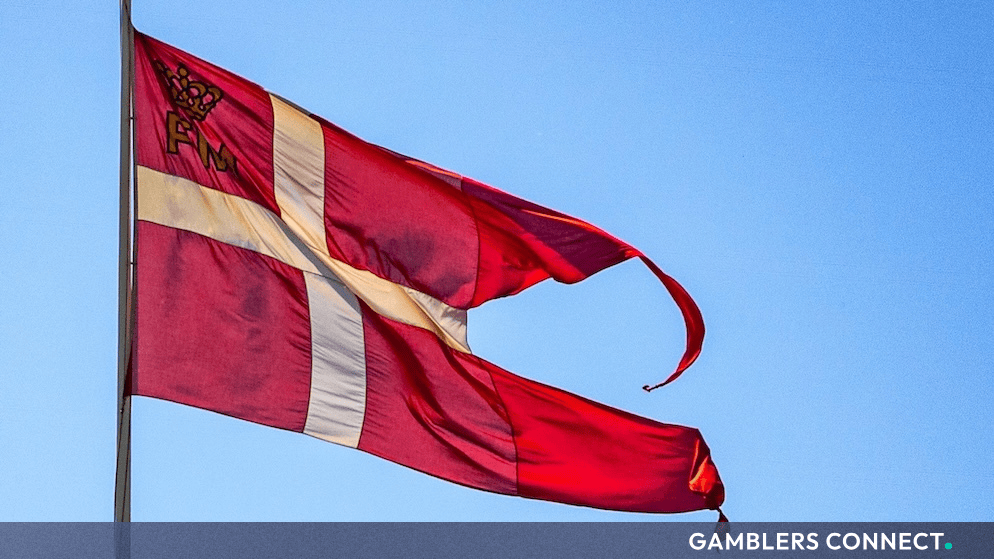 A fluttering national flag against a bright blue sky, representing regulatory oversight and institutional governance.