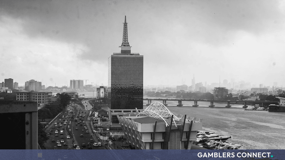 Black and white aerial cityscape of Lagos, Nigeria, showcasing urban architecture, waterways, and roadways.