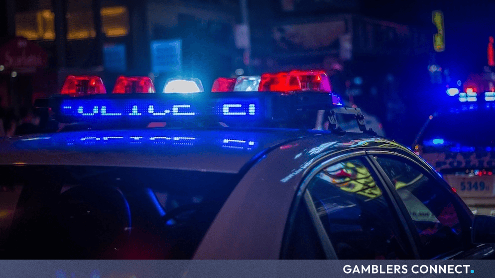 Close-up of emergency response vehicle with flashing blue and red lights during night operations in an urban centre.