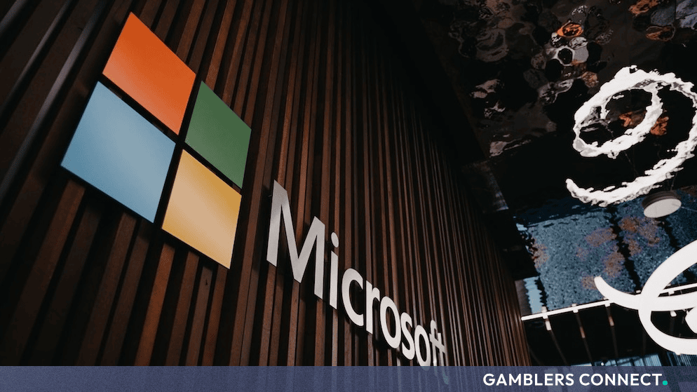 Interior view of a Microsoft office featuring the company's colored logo mounted on a wooden slat wall.
