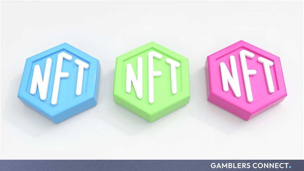 Three colorful 3D-rendered hexagonal blocks displaying the letters NFT in blue, green, and pink against a clean white background.