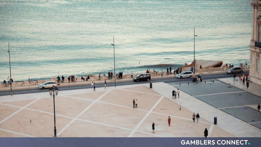 Aerial view of a public plaza and waterfront walkway in Lisbon near the summit venue.